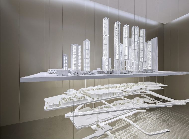 Suspended art installation of a white city model in two layers in a lobby