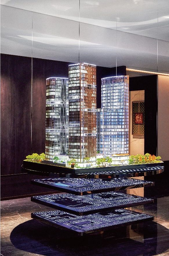 Suspended model of two towers above layers showing the car parking