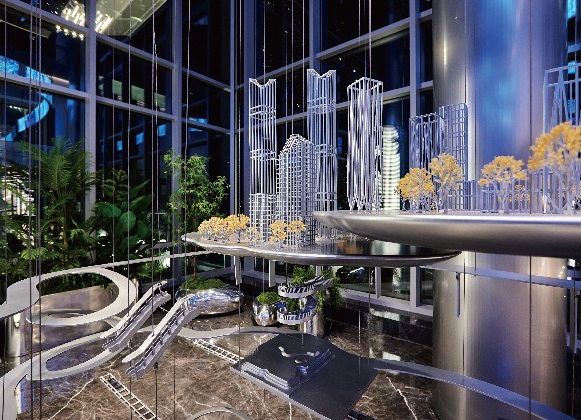 Suspended art installation of a transparent city model beside a marble stair