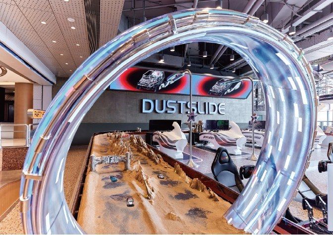 Interactive display with metal tracks and sand inside a shopping centre