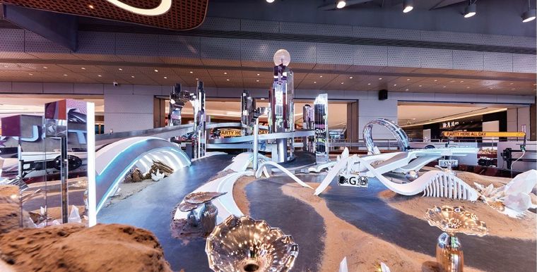Model of an indoor racing track with a desert scene — several views