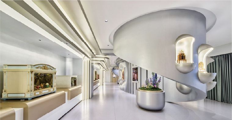 Curved exhibition corridor with vertical fins and framed exhibits