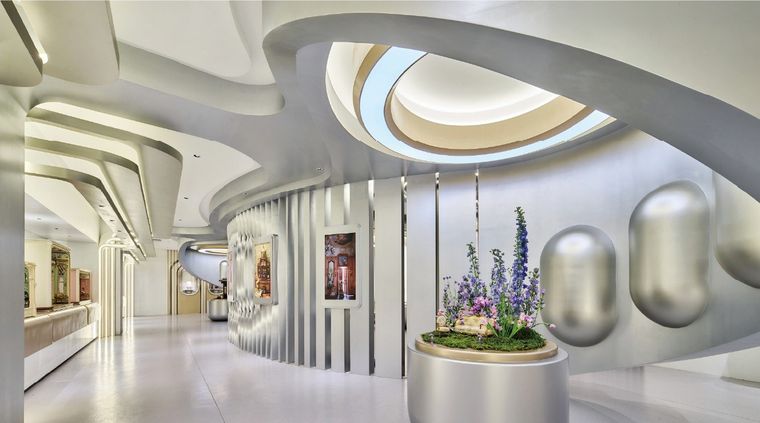 Exhibition hall with silver niches holding pieces and miniature models