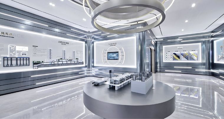 Exhibition corridor with concealed lighting and models on successive plinths