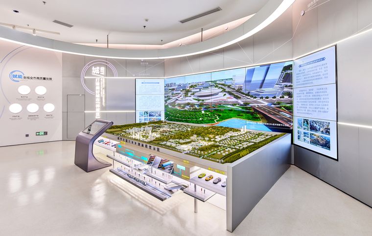 Planning exhibition room with a lit model and explanatory panels