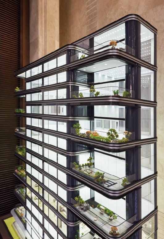 Model of a green tower from a low angle bringing out the planted balconies