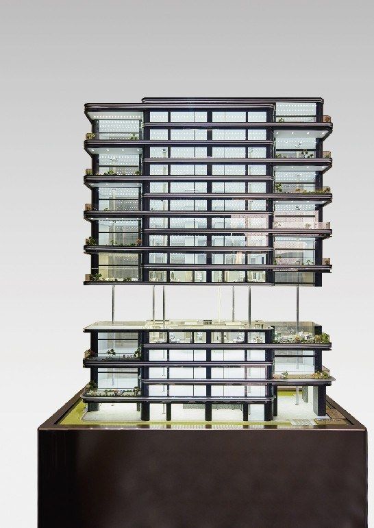 Model of a residential tower with planted balconies on a dark base