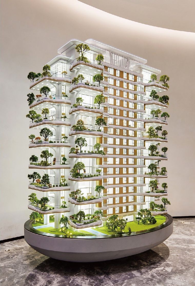 Model of a tower with hanging gardens on an oval base in a showroom