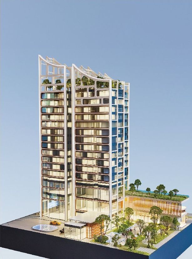 Model of two residential towers with green roofs and a retail podium