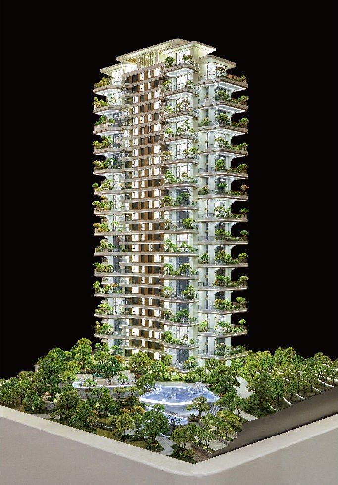Model of a residential tower with planted balconies on a white base against black