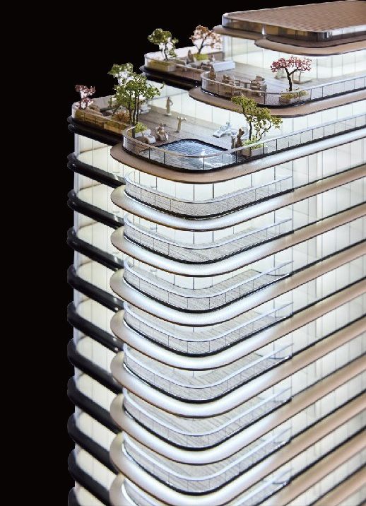 Close view of the crown of a residential tower and its planted balconies