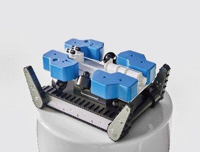 Overhead model of an industrial robot showing the tracks