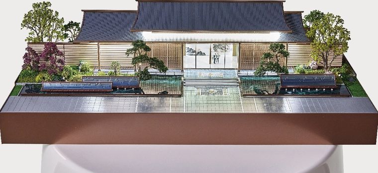 Model of a traditional-style building with water features and garden landscaping