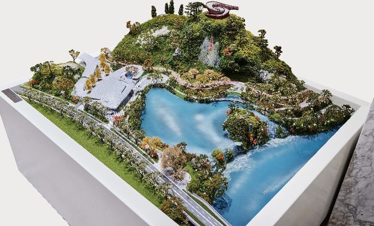 Model of a mountain park with a lake, trails and green terrain