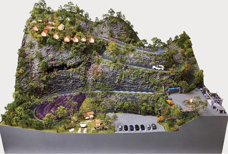 Model of a mountain slope with trails, cabins and terraced planting