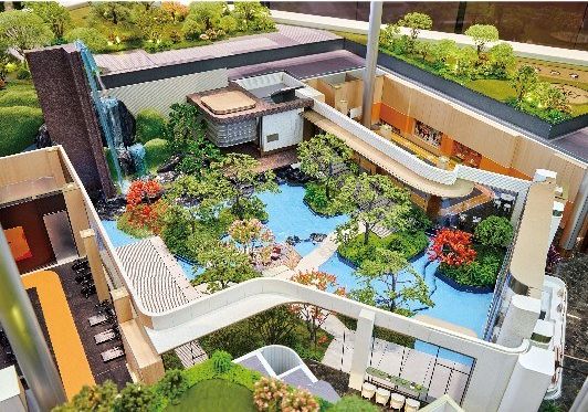 Model of an internal garden with a pool and waterfall between residential buildings