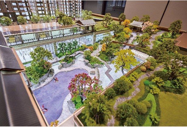Model of a traditional Chinese courtyard with a pond and stone paths