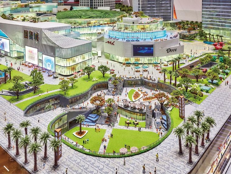Model of a shopping centre plaza with palms and planted areas