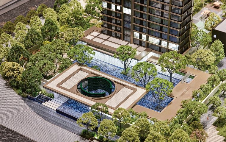 Model of a residential courtyard with a circular pool, water features and trees