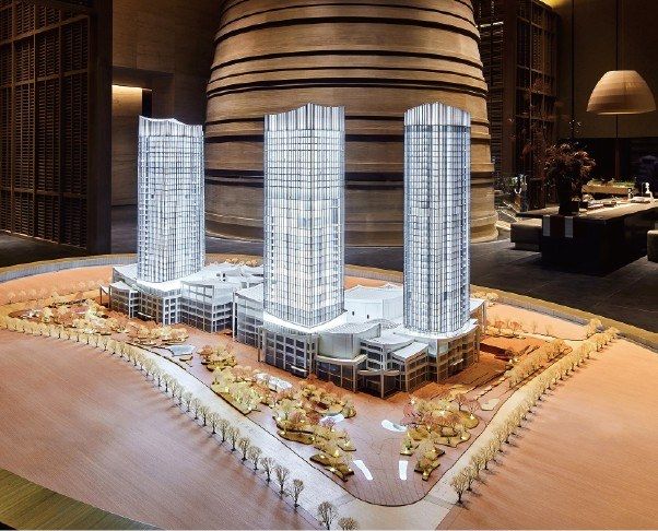 Model of a riverfront with office and residential towers and bridges