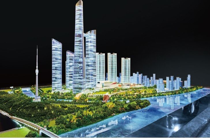Model of a business project on a white base in a wide showroom
