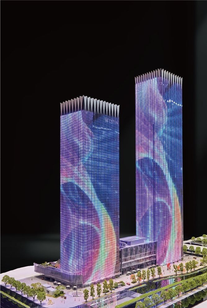 Model of office and residential towers with the lake and site landscaping
