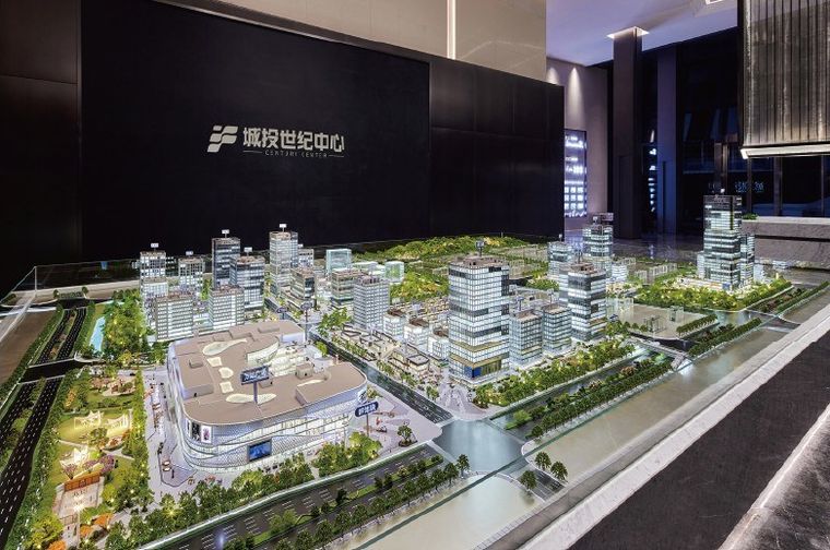 Model of a waterfront with office and residential towers on a canal bank