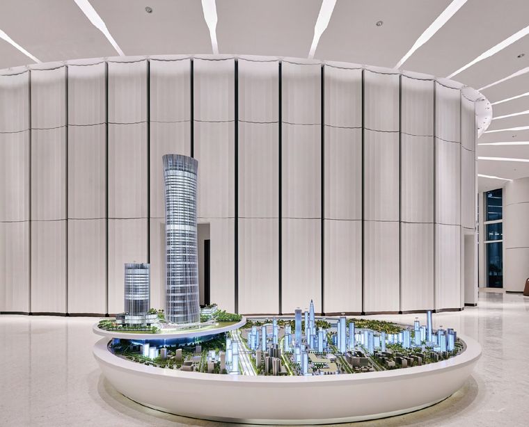 Model of a business complex lit at night on a reflective base