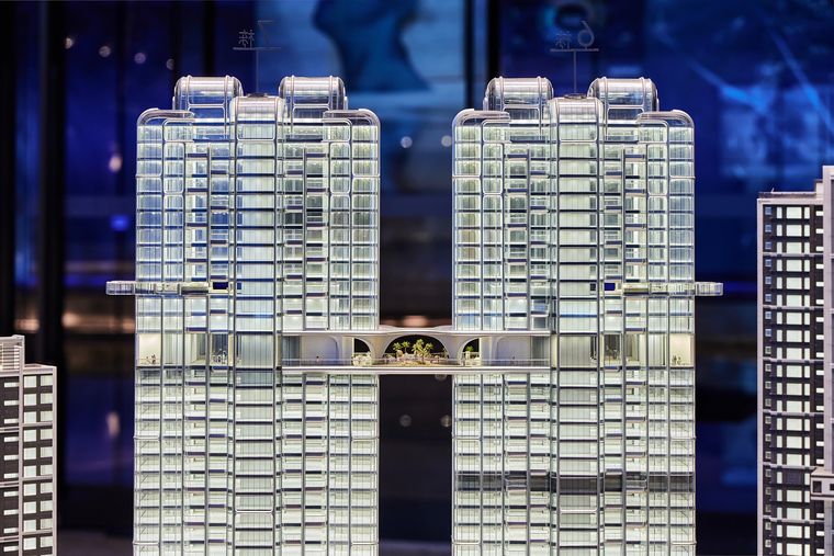 Two glazed towers in front of a display screen in a reception hall