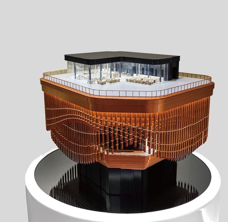 Model of a public building with inclined canopies and a water feature on a white base
