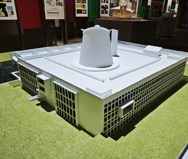 Model of an administrative building with sloping roofs and site landscaping