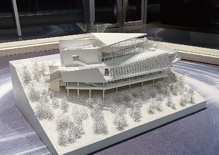 Model of a public building with green roofs and several entrances