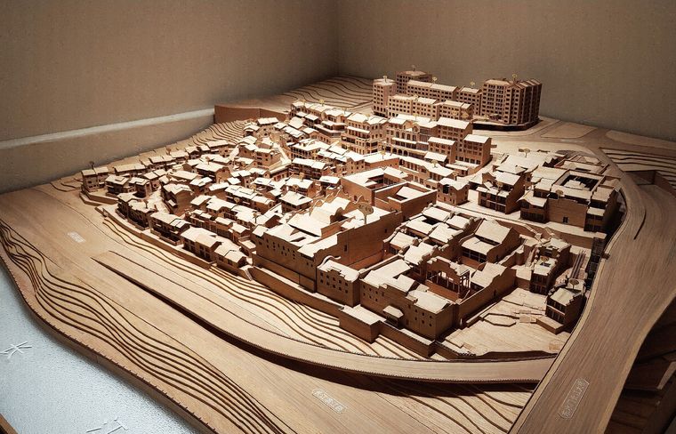 Timber model of a historic city under raking light that brings out the massing