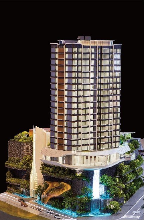 Model of a residential tower with a retail podium against black