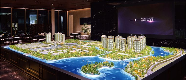 Model of an extended coastal residential project in an exhibition hall