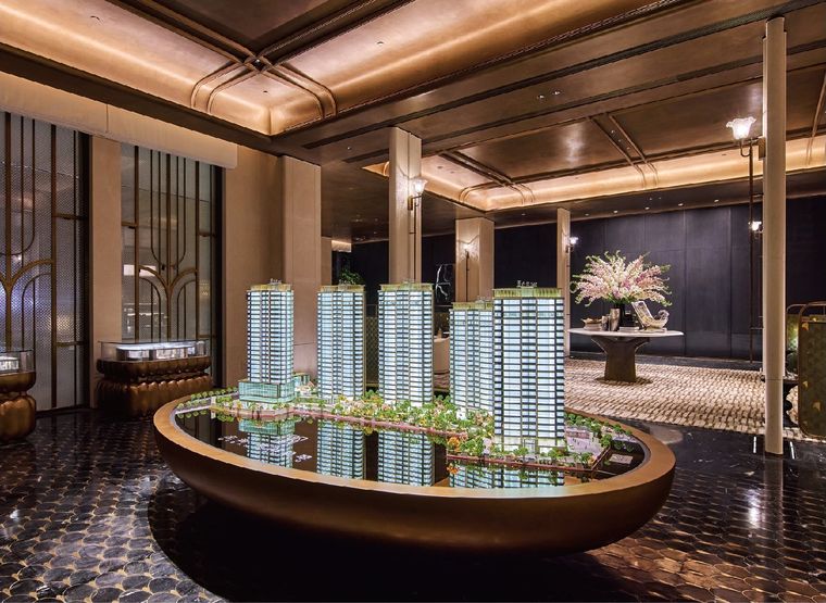 Model of four residential towers on an oval copper base
