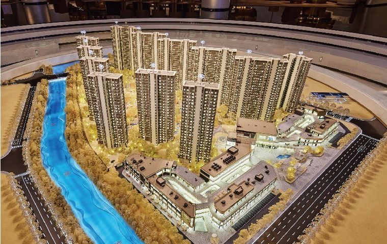Model of a large residential complex with the river and retail amenities