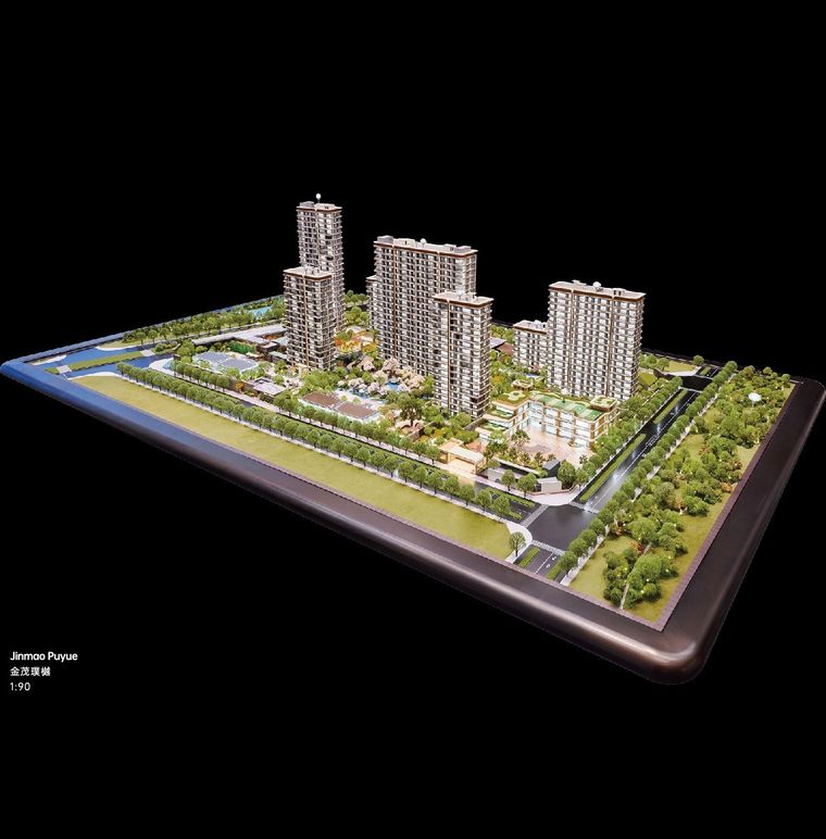 Model of a residential complex on a black base against a dark ground
