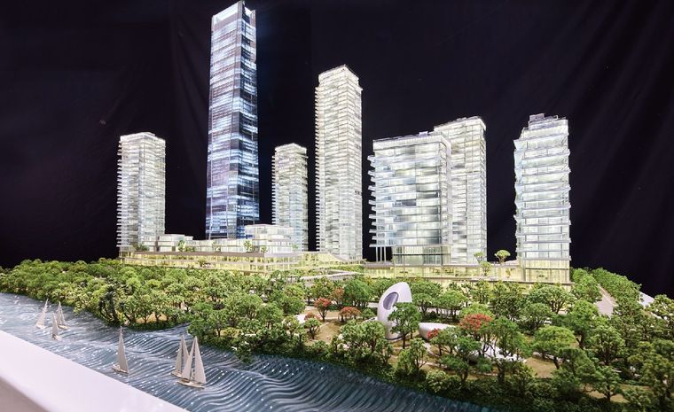 Model of residential towers on a waterfront with sailing boats