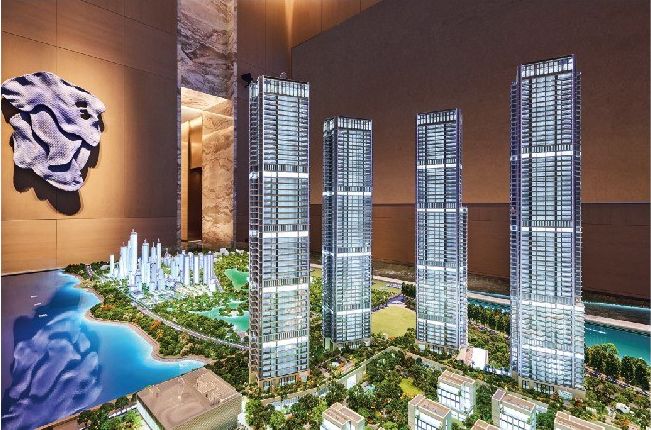 Model of tall residential towers with the lake and high ground behind