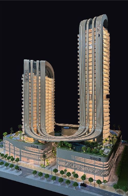 Model of two residential towers with a curved facade against black