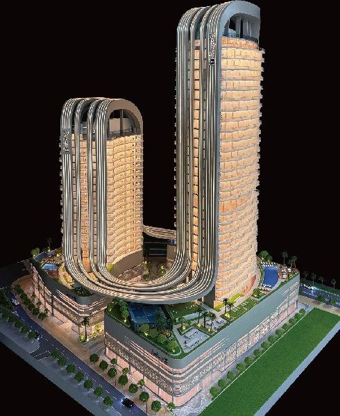 Model of a residential tower with a curved facade and a retail podium