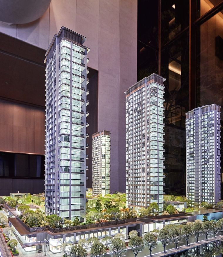 Model of a tall residential tower with the surrounding buildings in a lobby