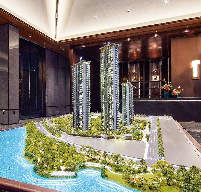 Model of two residential towers with the lake in a luxury lobby