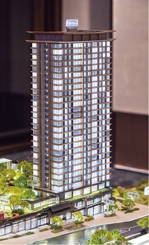 Model of a residential tower with its retail podium and garden