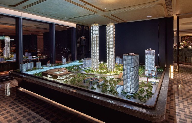 Model of residential towers inside a glass vitrine with a night view