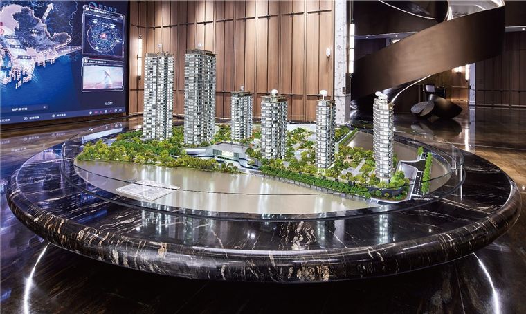 Model of residential towers on a circular black marble base