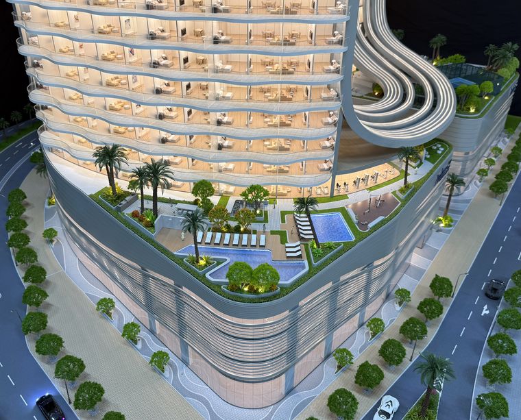 Aerial view of a terraced residential complex with pools, gardens and parking