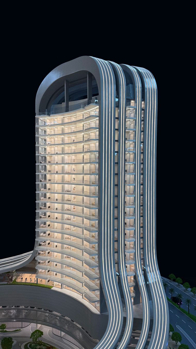 Tall residential tower with rounded balconies on a landscaped base