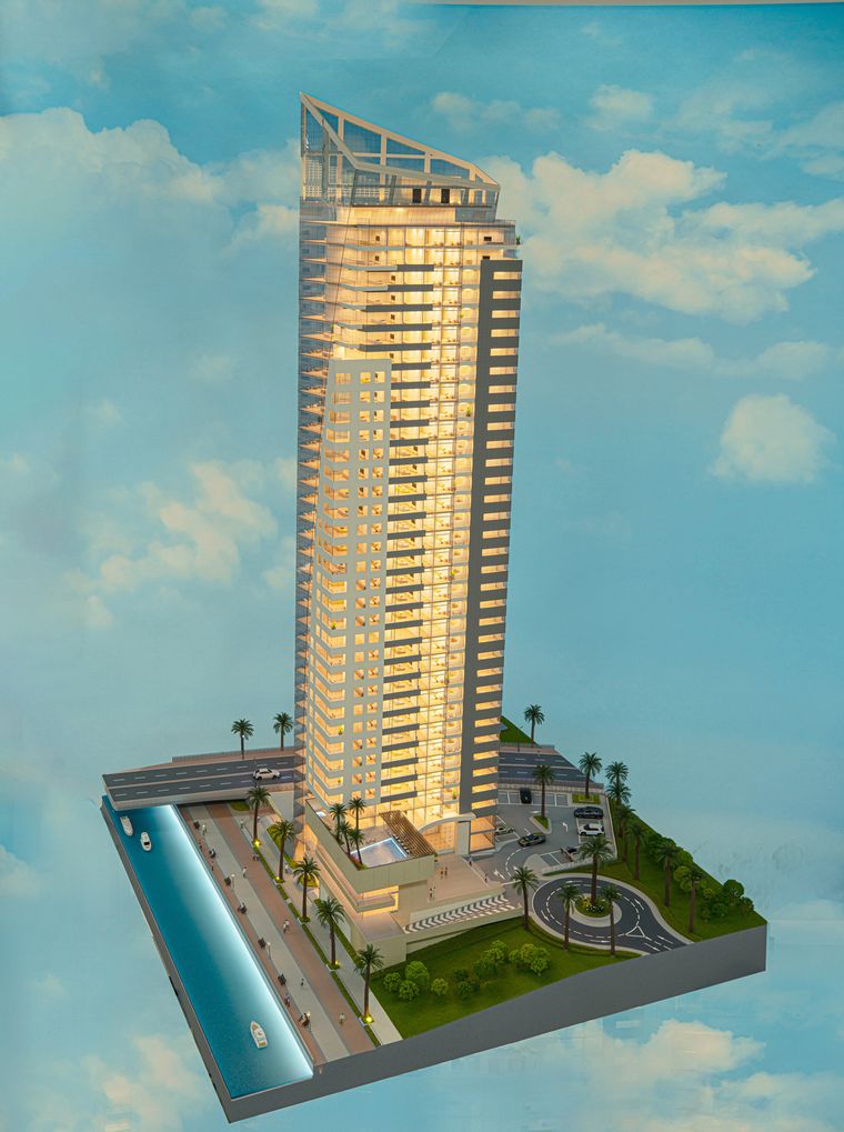 Residential tower against a painted sky backdrop with water at the base